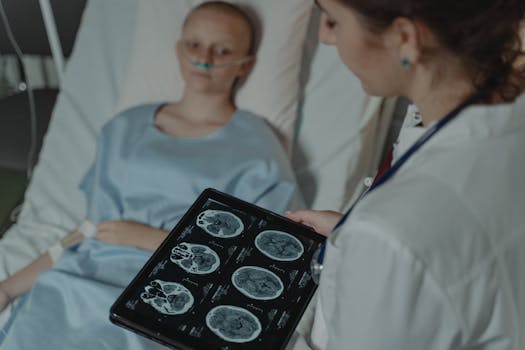 A doctor analyzes brain scans on a digital tablet beside a patient in a hospital bed.