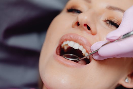 Close-up of a patient getting a dental checkup with dental tools in use.