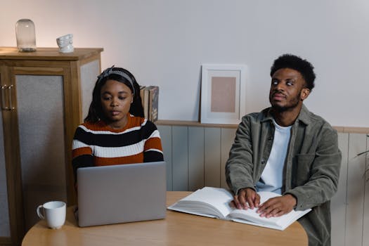 Individuals engage with technology and braille, highlighting inclusivity.