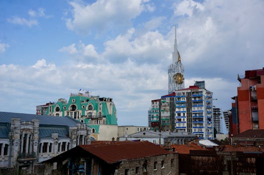 Urban skyline of Batumi showcasing unique architectural styles under cloudy skies.